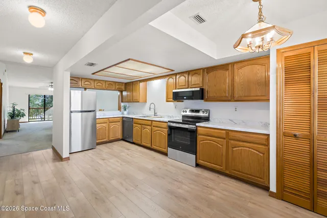 a kitchen with stainless steel appliances granite countertop a refrigerator sink and cabinets
