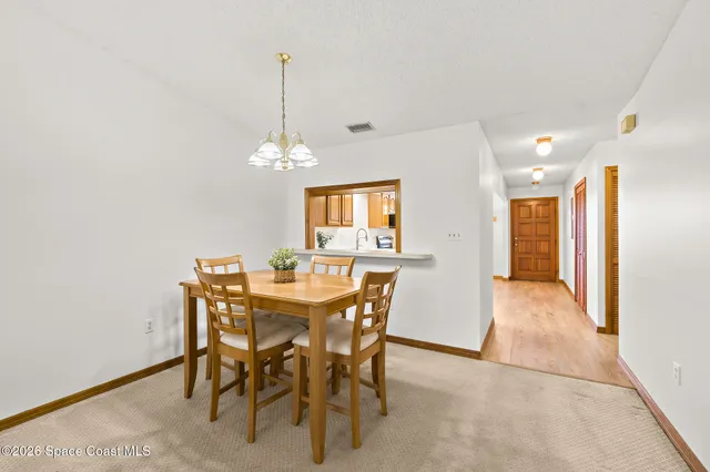 a view of a dining room with furniture and window
