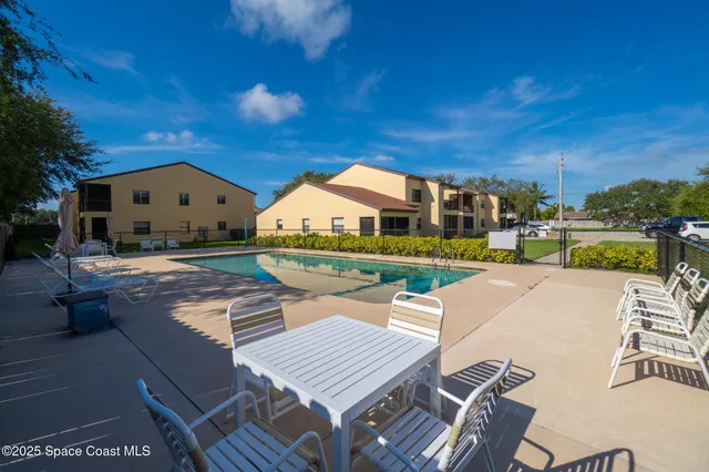 a view of swimming pool with outdoor seating and a patio
