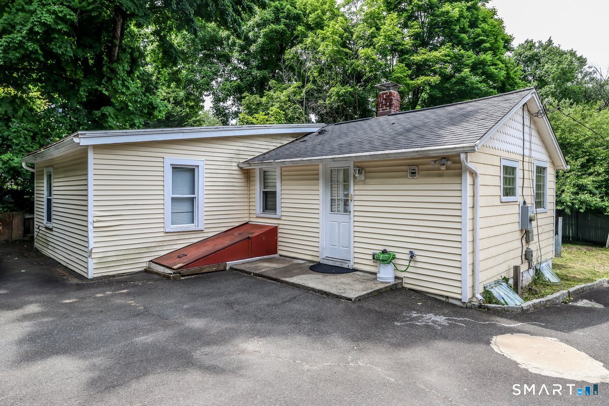 70 Dodgingtown Road Bethel, CT 06801 - Photo 21 of 27 a view of a house with a backyard and a garage