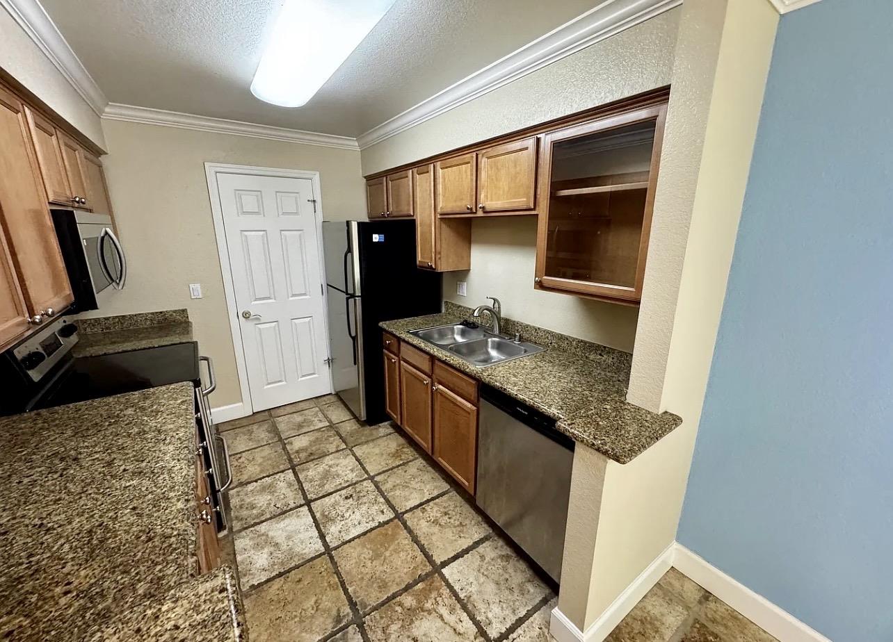 331 Eastridge Drive San Ramon, CA 94582 - Photo 3 of 15 a kitchen with granite countertop a stove and a refrigerator