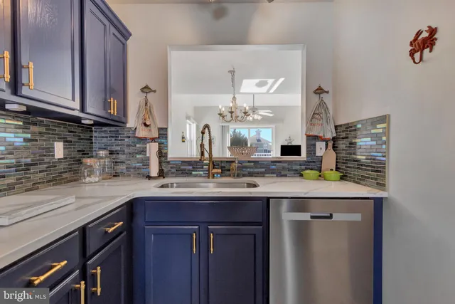 a kitchen with a sink a refrigerator and cabinets