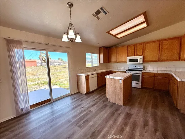 a kitchen with a stove a sink and a refrigerator