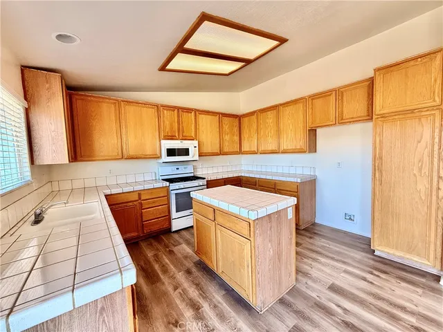 a stove top oven sitting inside of a kitchen