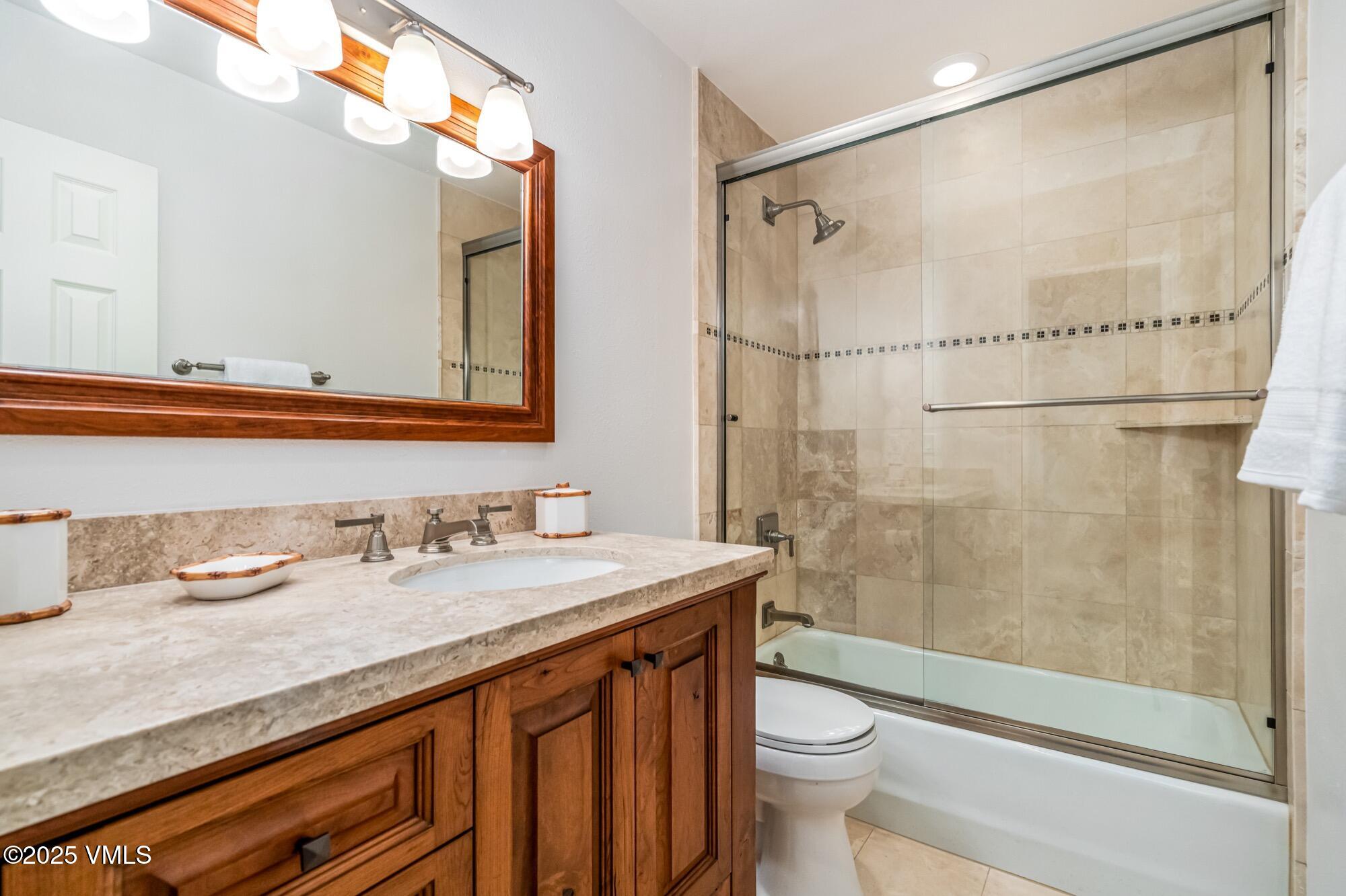 945 Red Sandstone Road, Unit A5 Vail, CO 81657 - Photo 26 of 38 a bathroom with a sink a toilet and shower