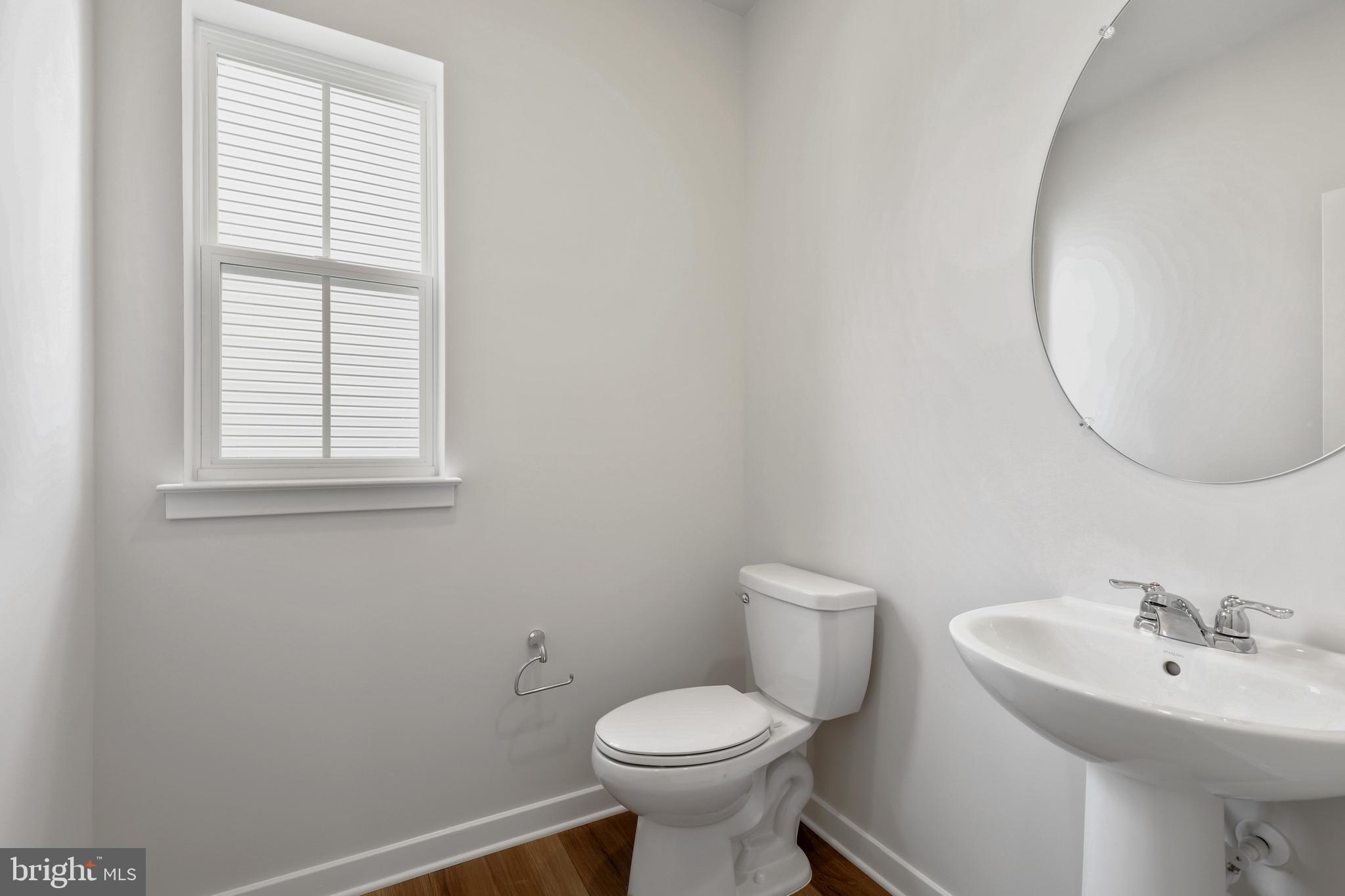 1261 Red Clover Lane, Unit ASHTON 192 Ranson, WV 25438 - Photo 15 of 23 a bathroom with a toilet sink and mirror