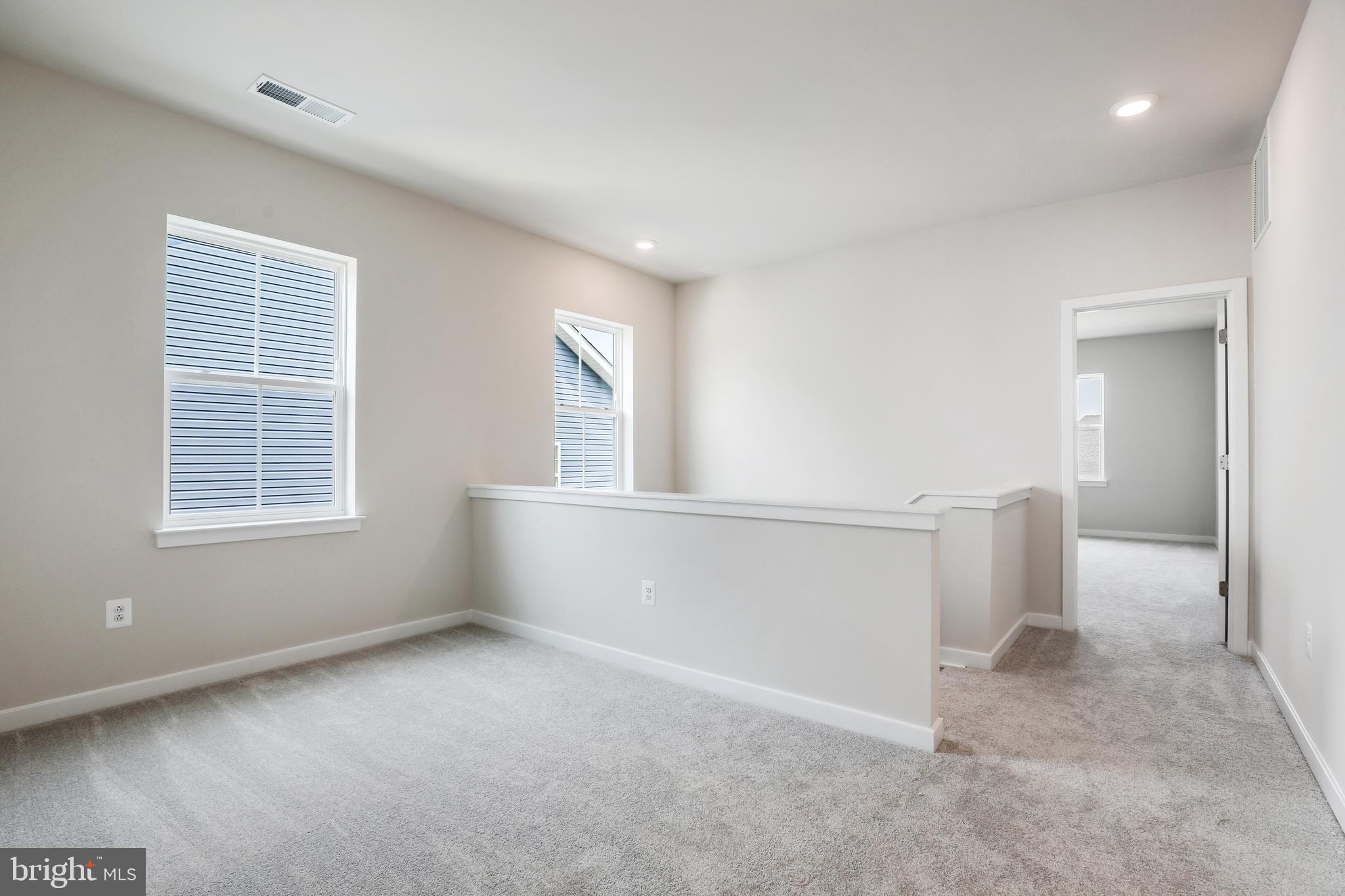 1261 Red Clover Lane, Unit ASHTON 192 Ranson, WV 25438 - Photo 16 of 23 an empty room with windows