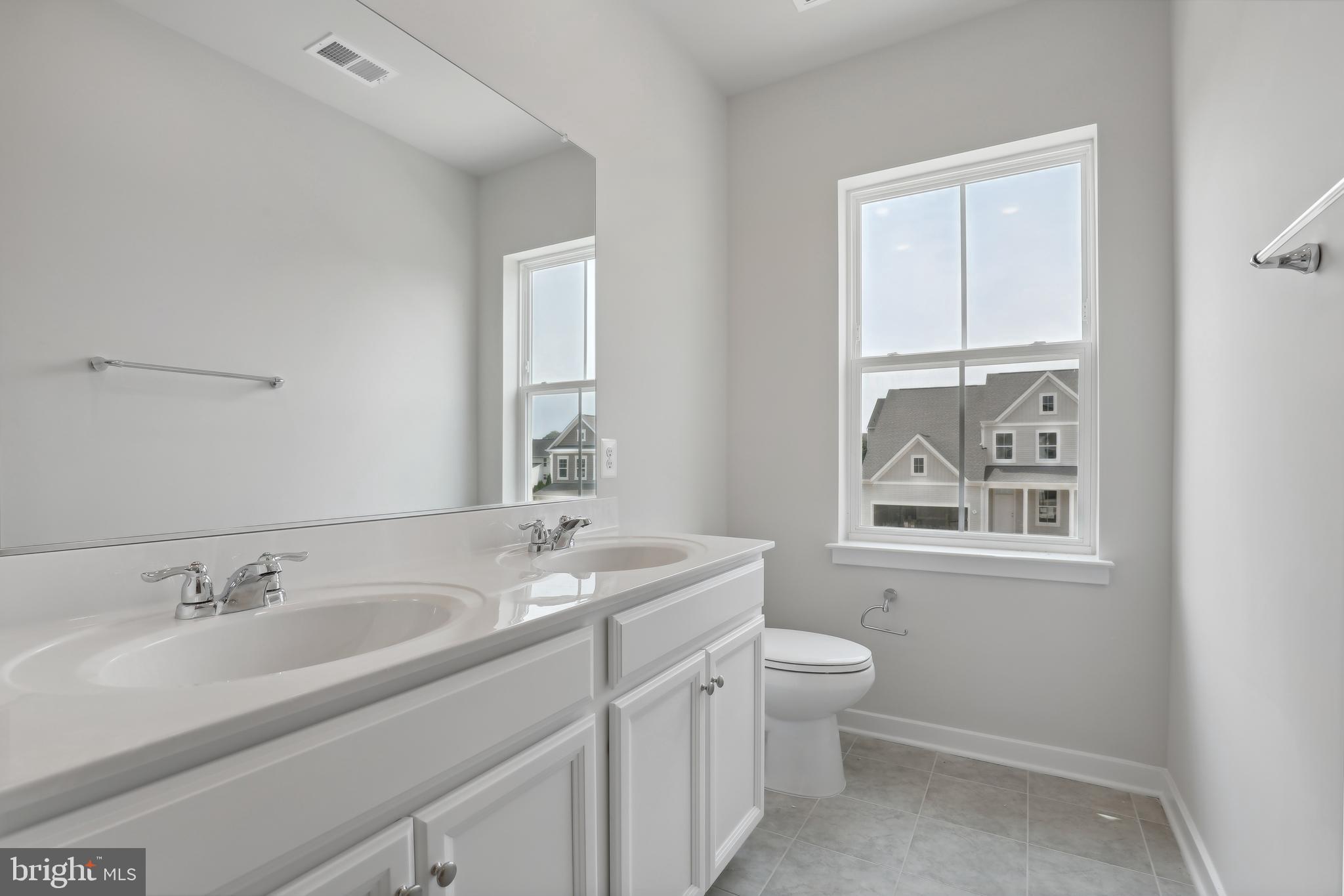 1261 Red Clover Lane, Unit ASHTON 192 Ranson, WV 25438 - Photo 17 of 23 a bathroom with a granite countertop sink toilet and mirror