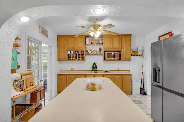 a kitchen with stainless steel appliances granite countertop a sink a stove cabinets counter space and a window