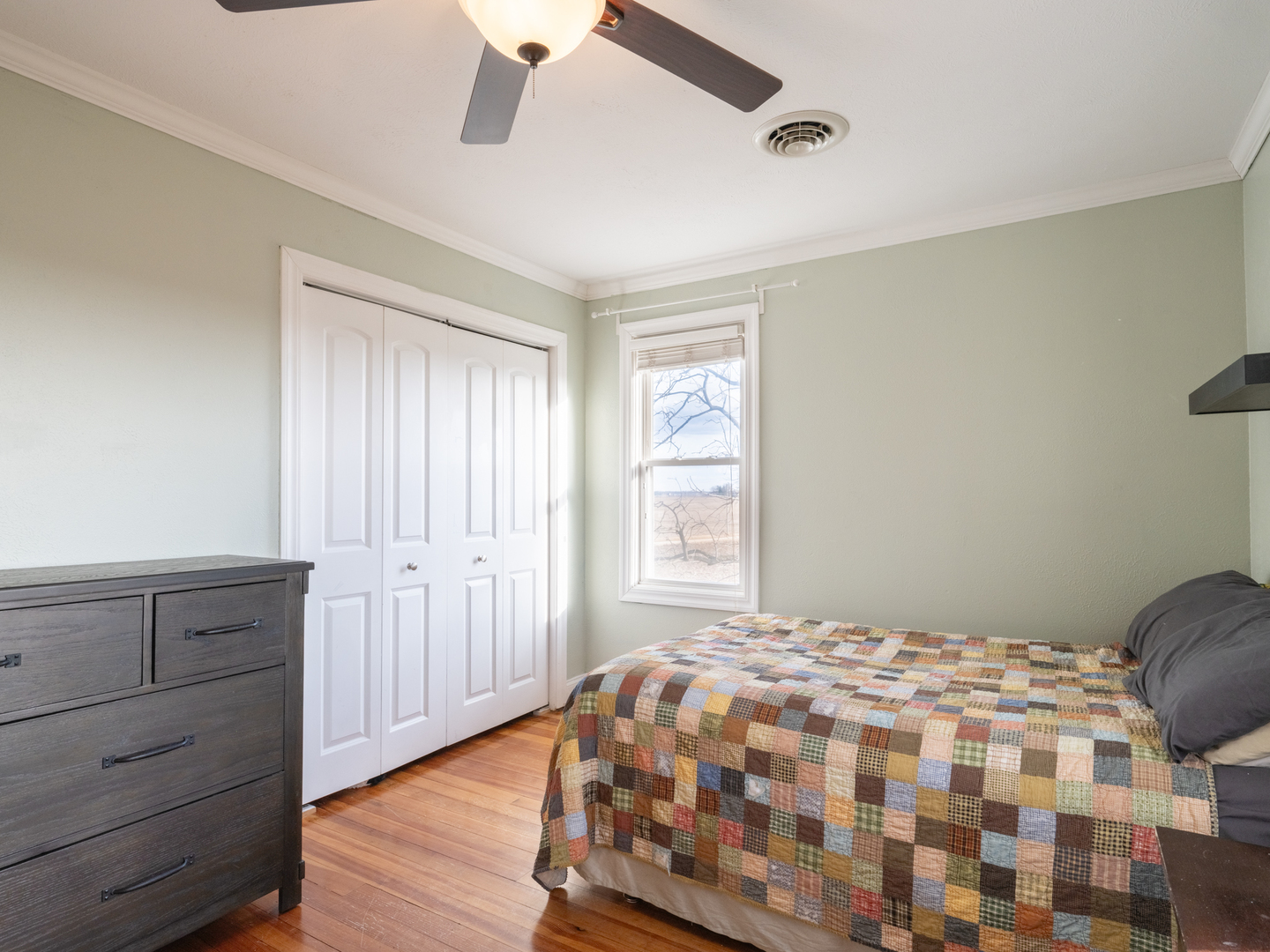 5631 Broadway Road Groveland, IL 61535 - Photo 10 of 41 a bedroom with a bed and wooden floor
