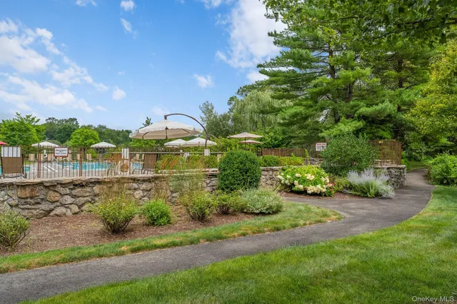 a view of a pathway with a garden