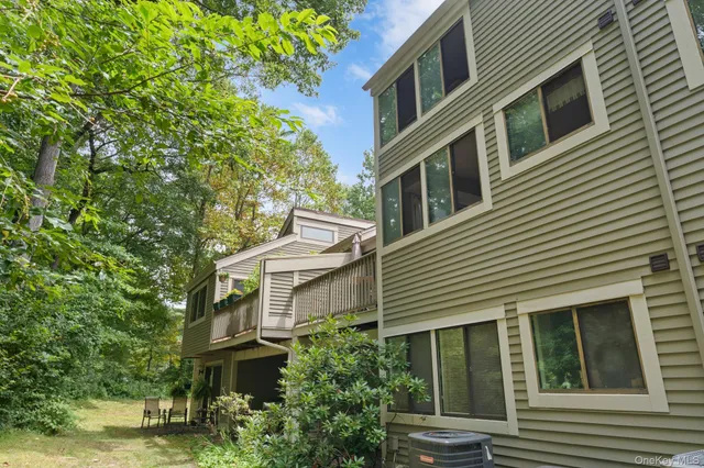 a view of a house with a yard and balcony