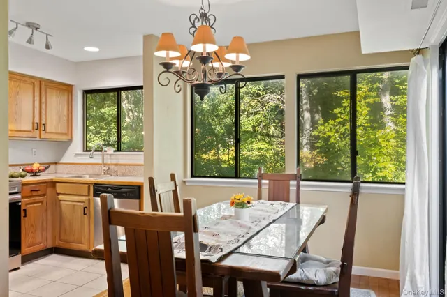 a dining room filled chandelier and wooden floor