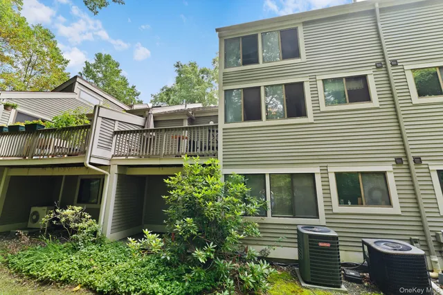 a view of house with a window and potted plants