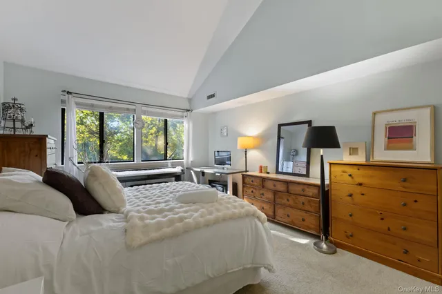 a bedroom with a large bed and a dresser