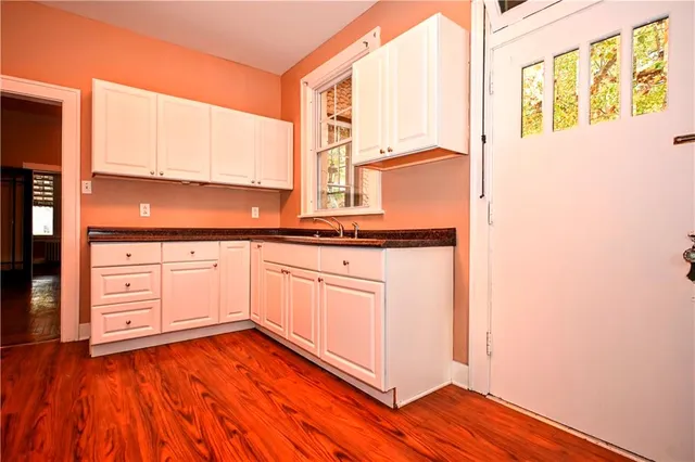 a kitchen with granite countertop wooden cabinets and white appliances