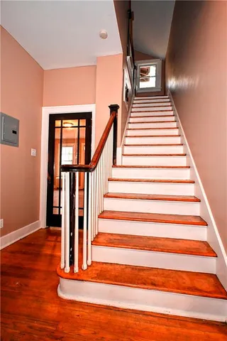 a view of entryway and hall with wooden floor