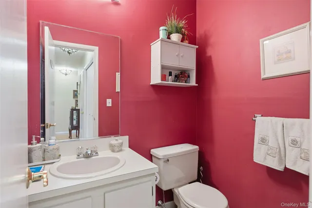 a bathroom with a toilet sink and mirror