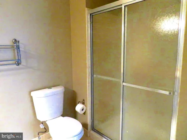 a white toilet sitting next to a bathroom sink