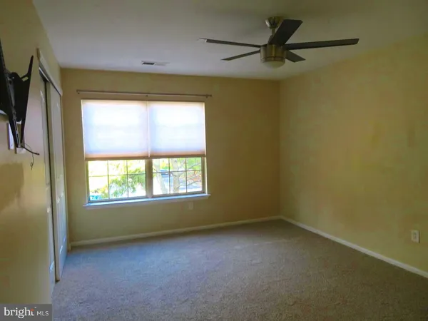 a view of a livingroom with a ceiling fan and a window