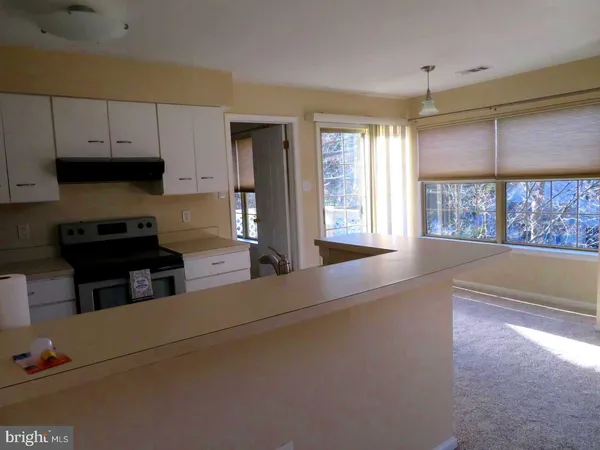 a kitchen with stainless steel appliances a stove a sink and a microwave