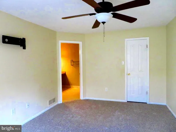 a view of an empty room with a bathroom