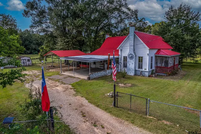 a view of a house with a yard potted plants