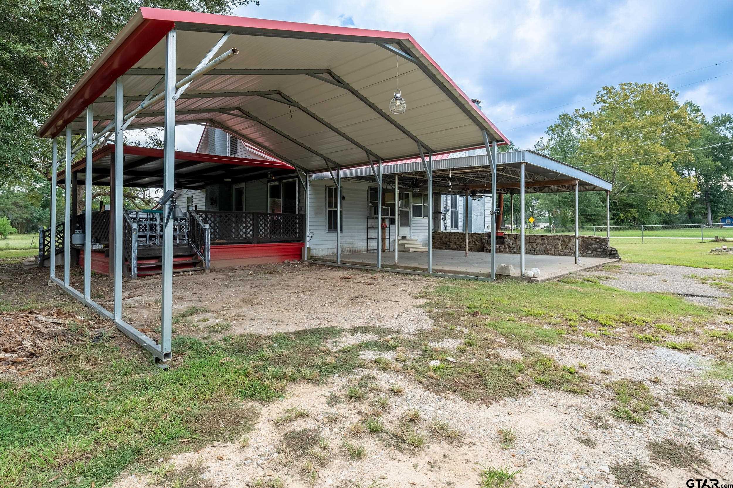 2888 Farm To Market Road 999 Gary, TX 75643 - Photo 22 of 46 a view of a house with a yard