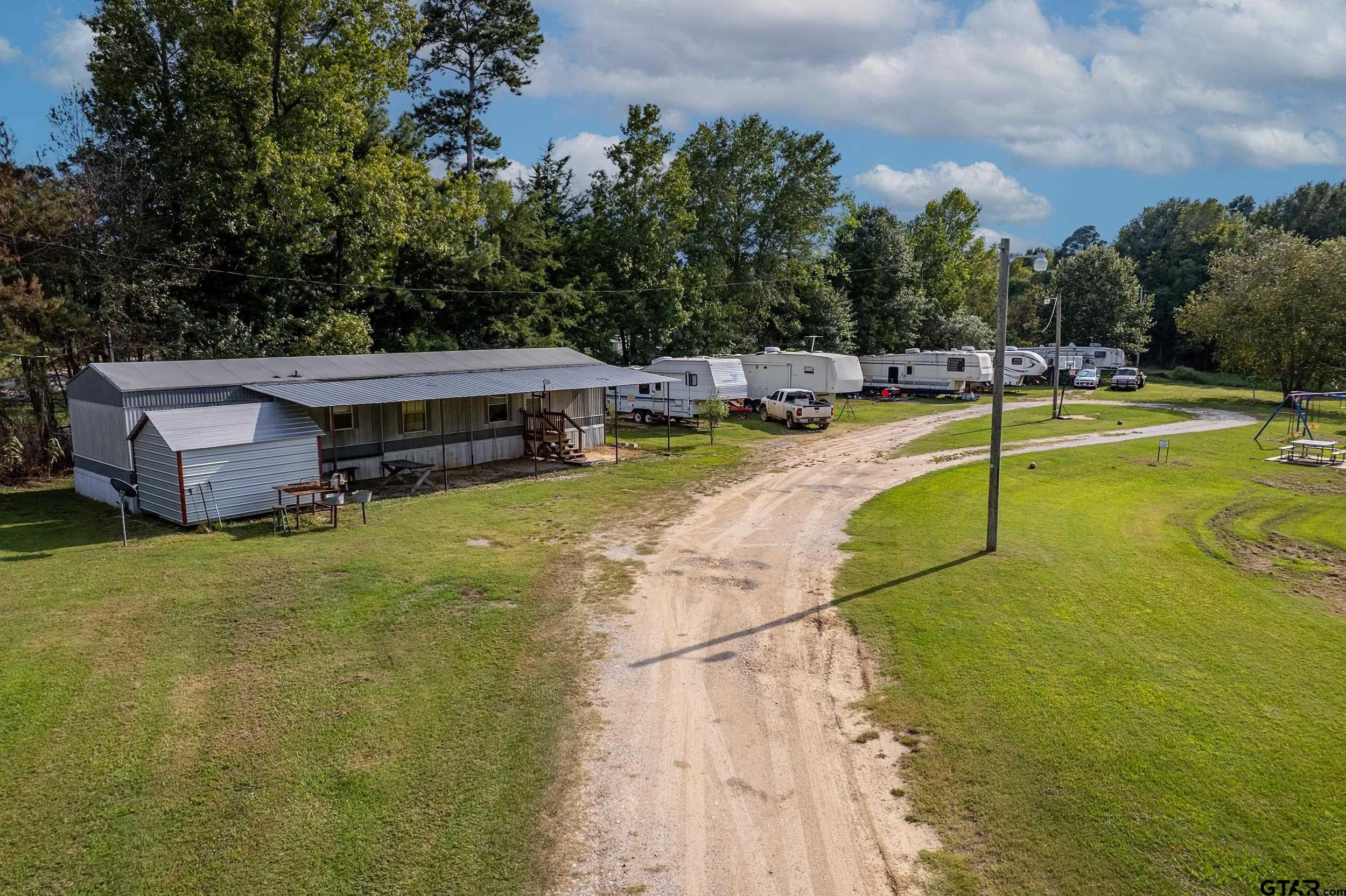 2888 Farm To Market Road 999 Gary, TX 75643 - Photo 25 of 46 a view of a swimming pool with a yard