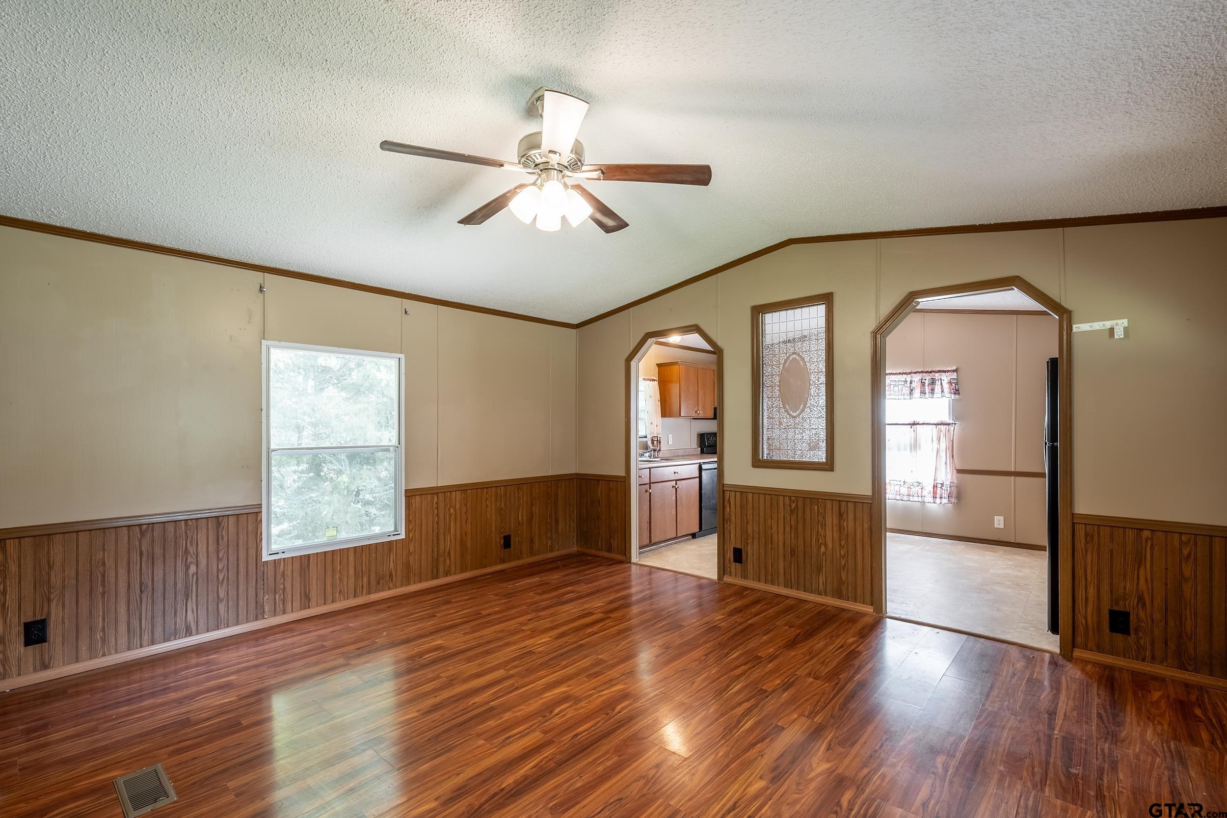 2888 Farm To Market Road 999 Gary, TX 75643 - Photo 28 of 46 a view of empty room with wooden floor and fan