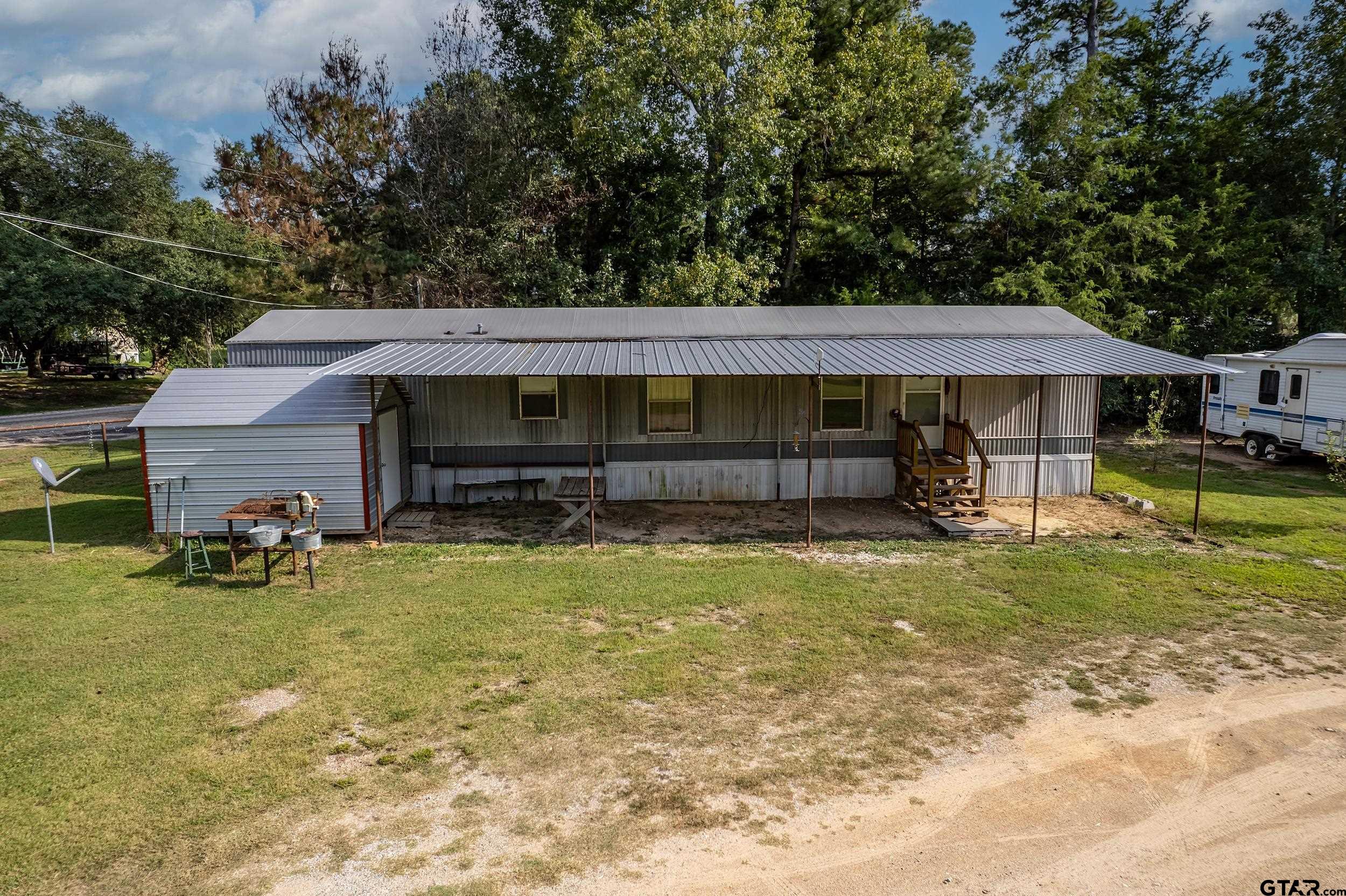 2888 Farm To Market Road 999 Gary, TX 75643 - Photo 37 of 46 a front view of a house with garden
