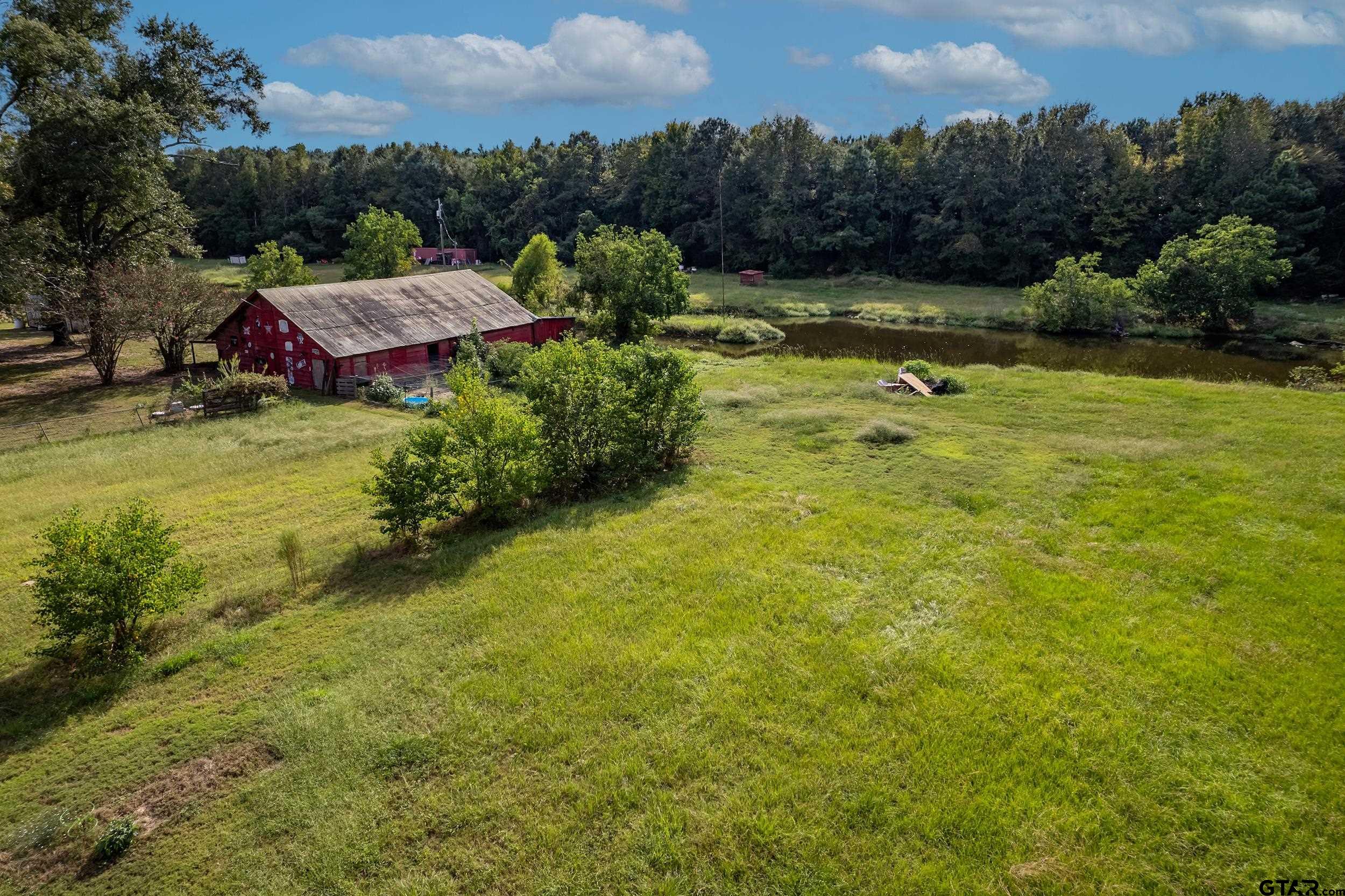 2888 Farm To Market Road 999 Gary, TX 75643 - Photo 45 of 46 an aerial view of a house with pool and a yard