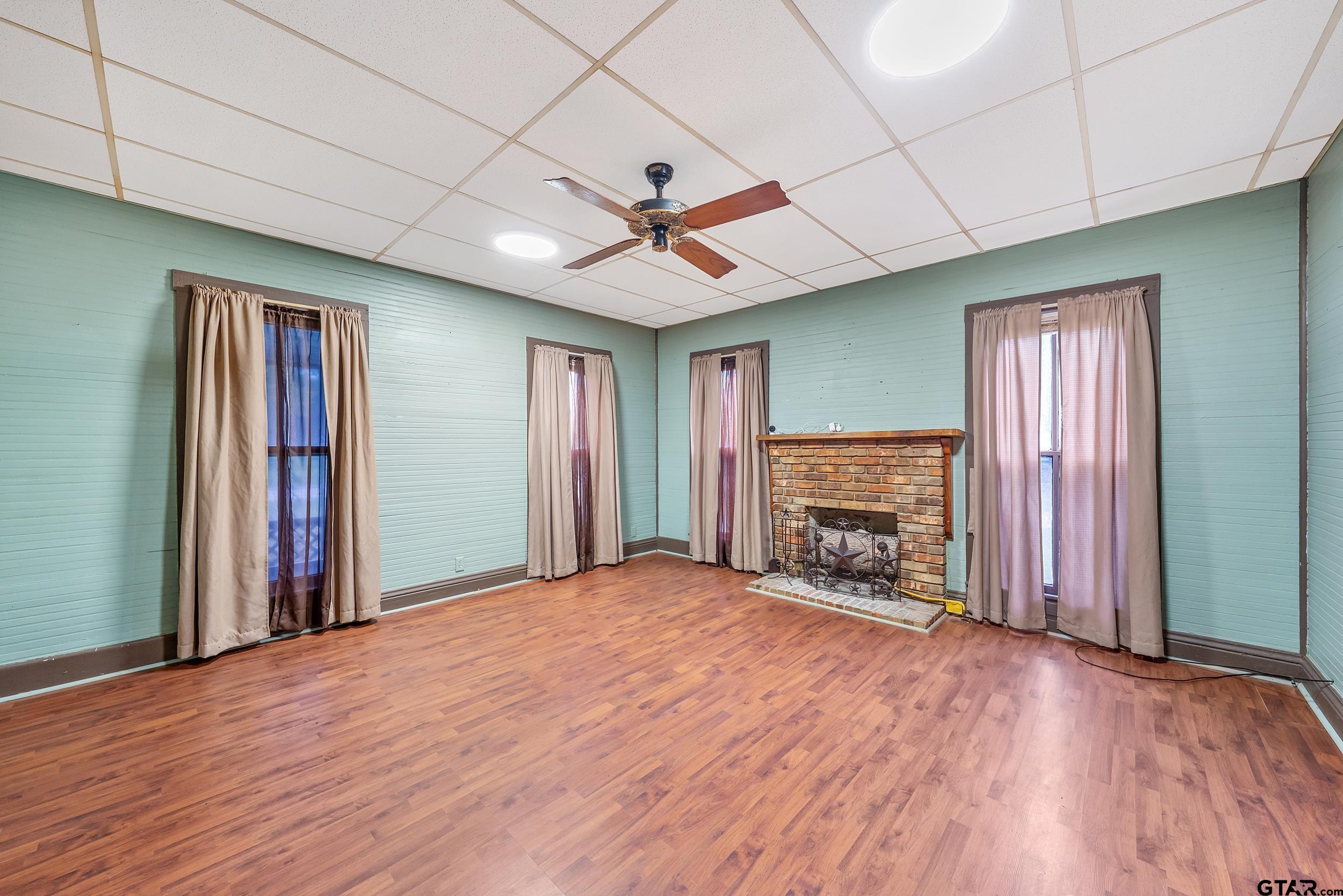 2888 Farm To Market Road 999 Gary, TX 75643 - Photo 8 of 46 a view of an empty room with a fireplace and a window