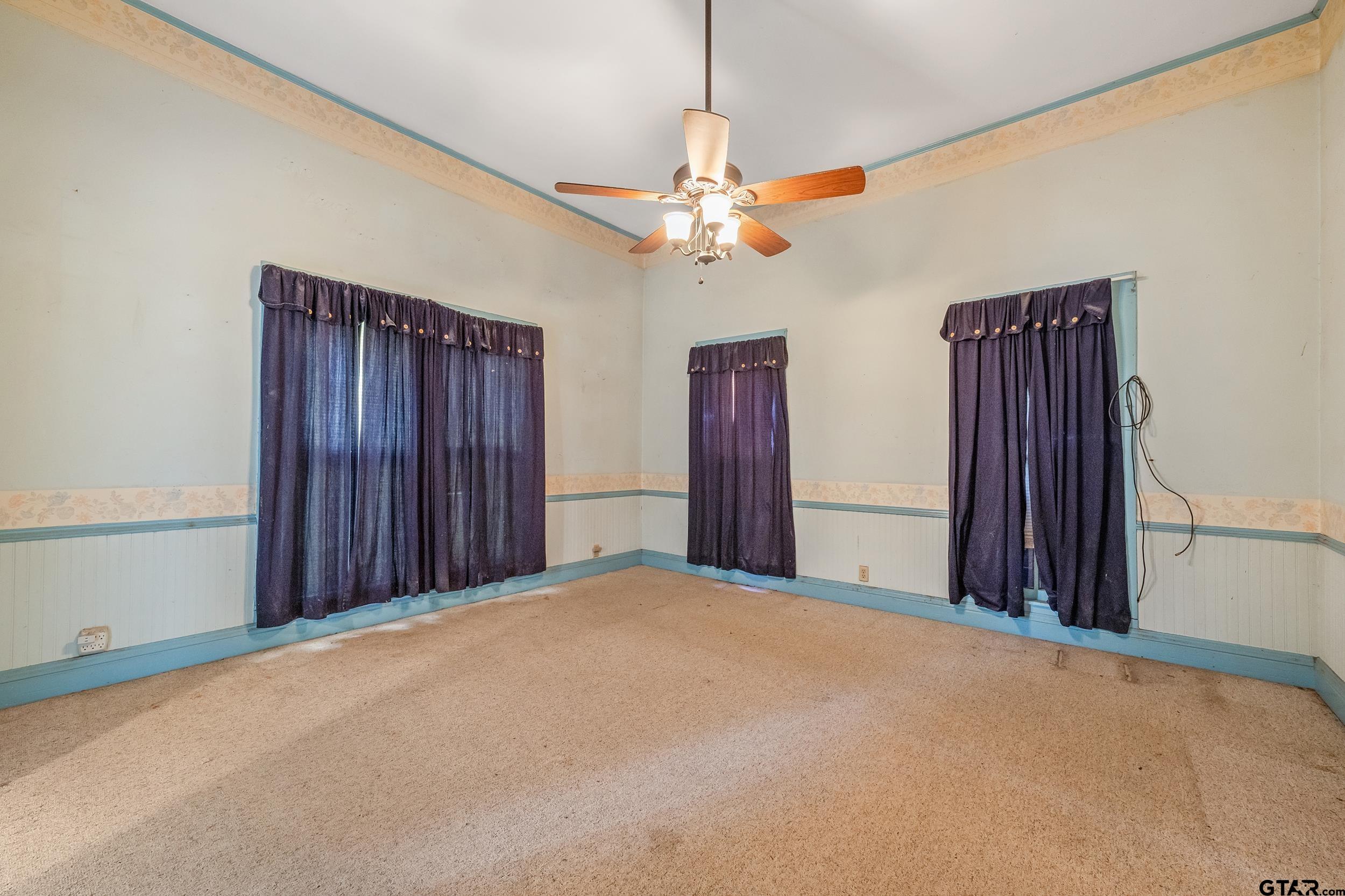 2888 Farm To Market Road 999 Gary, TX 75643 - Photo 10 of 46 a view of a bedroom with a ceiling fan and a closet