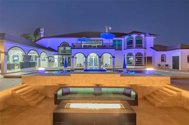 a living room with furniture and a view of kitchen