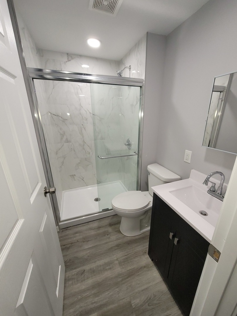133 Kingston Road Bolingbrook, IL 60440 - Photo 13 of 19 a bathroom with a toilet sink and shower