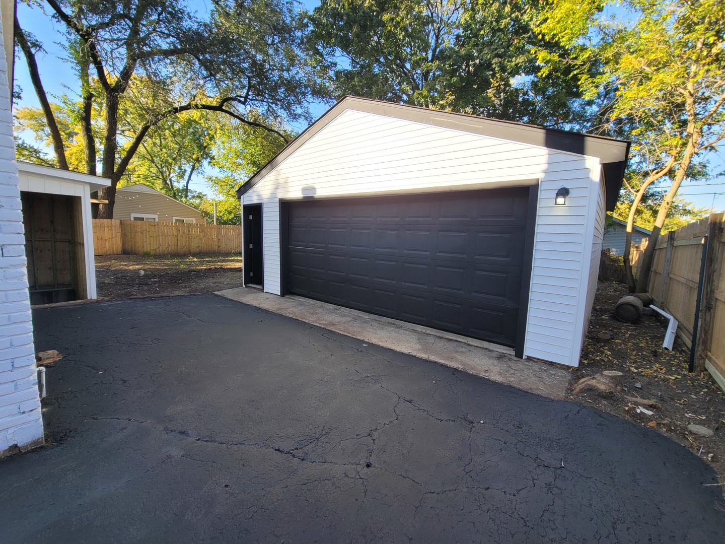 133 Kingston Road Bolingbrook, IL 60440 - Photo 18 of 19 a view of a house with a tree and wooden fence