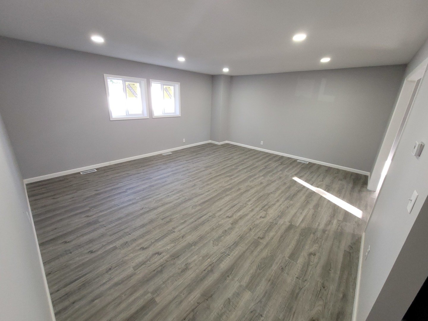 133 Kingston Road Bolingbrook, IL 60440 - Photo 4 of 19 an empty room with wooden floor and windows