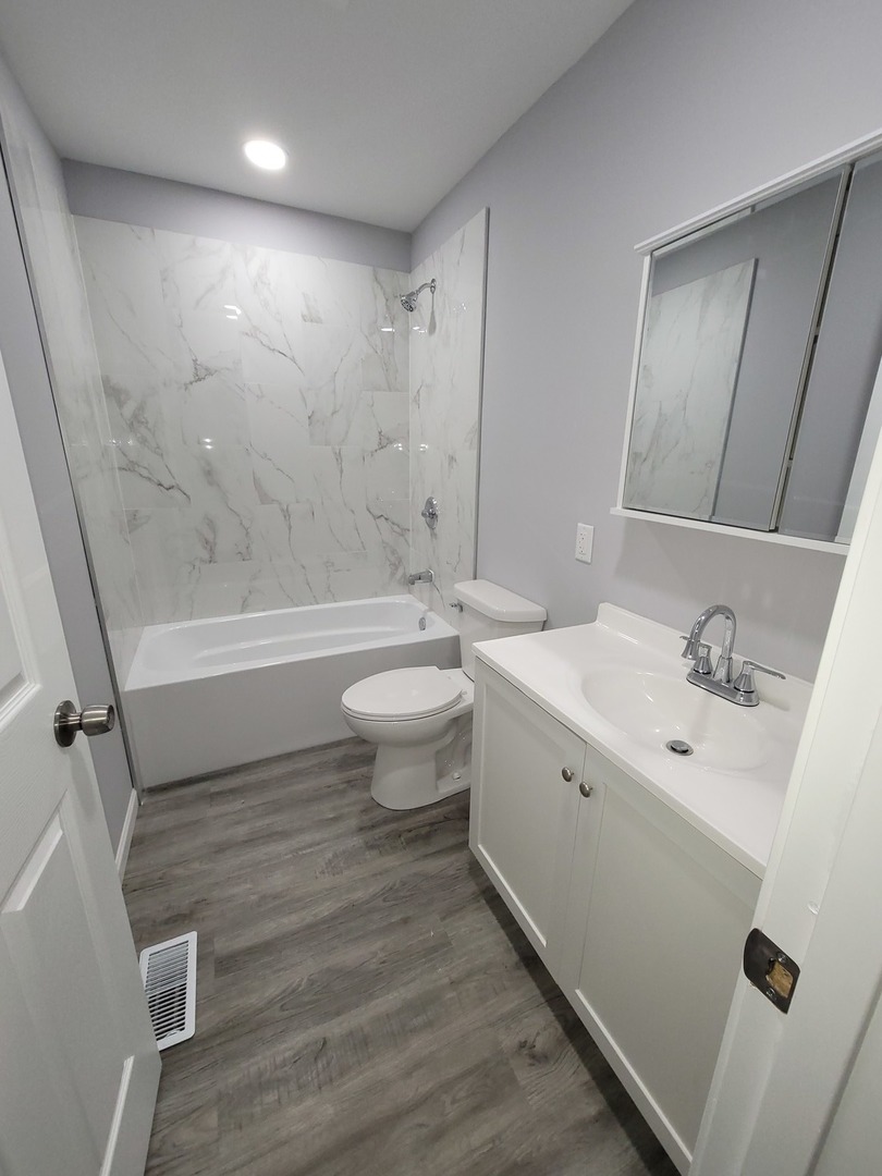 133 Kingston Road Bolingbrook, IL 60440 - Photo 7 of 19 a bathroom with a sink a toilet and shower
