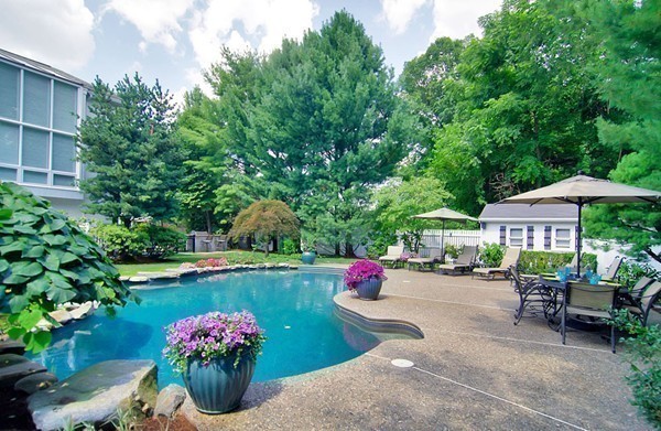 a view of a garden with patio and furniture