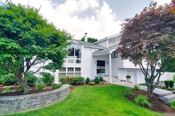 10 Patten Circle Newton, MA 02459 - Photo 2 of 26 a front view of a house with a garden and trees