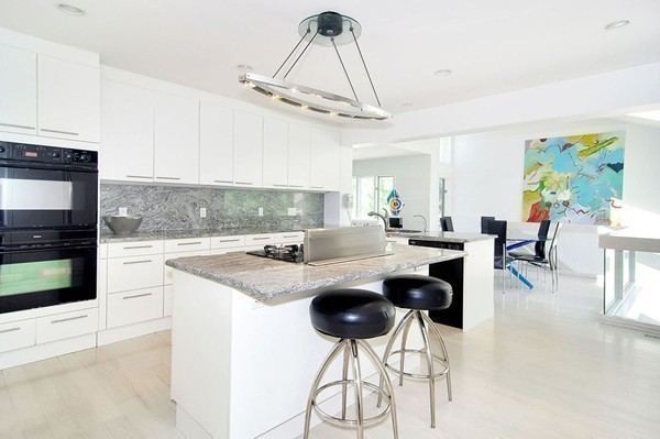 10 Patten Circle Newton, MA 02459 - Photo 7 of 26 a kitchen with stainless steel appliances kitchen island a stove a table and chairs in it