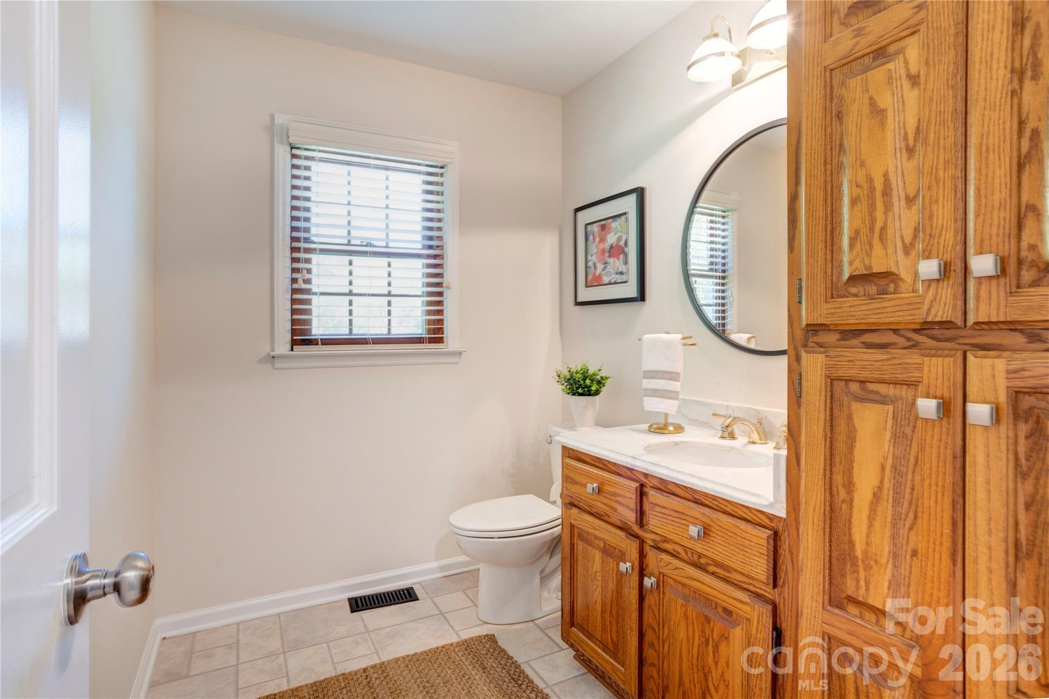 1188 Fawn Ridge Road Northwest Concord, NC 28027 - Photo 19 of 38 a bathroom with a toilet a sink and a mirror