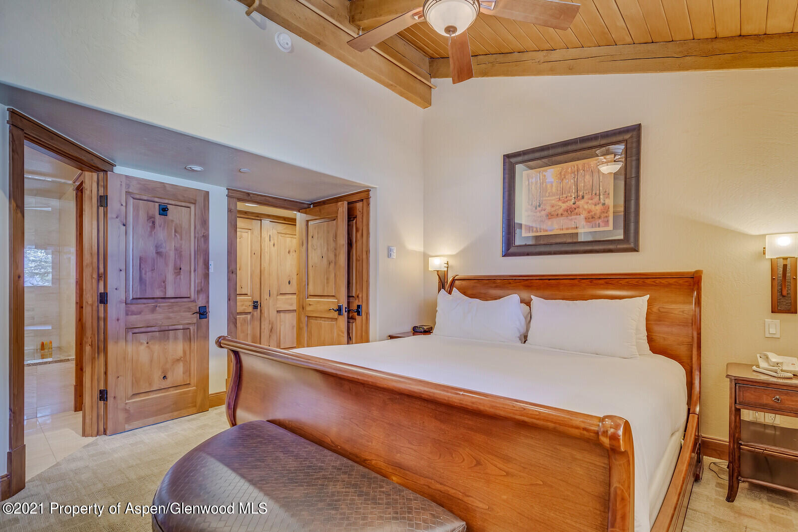 400 Wood Road, Unit 2302 Snowmass Village, CO 81615 - Photo 12 of 16 a bedroom with a bed and a chandelier