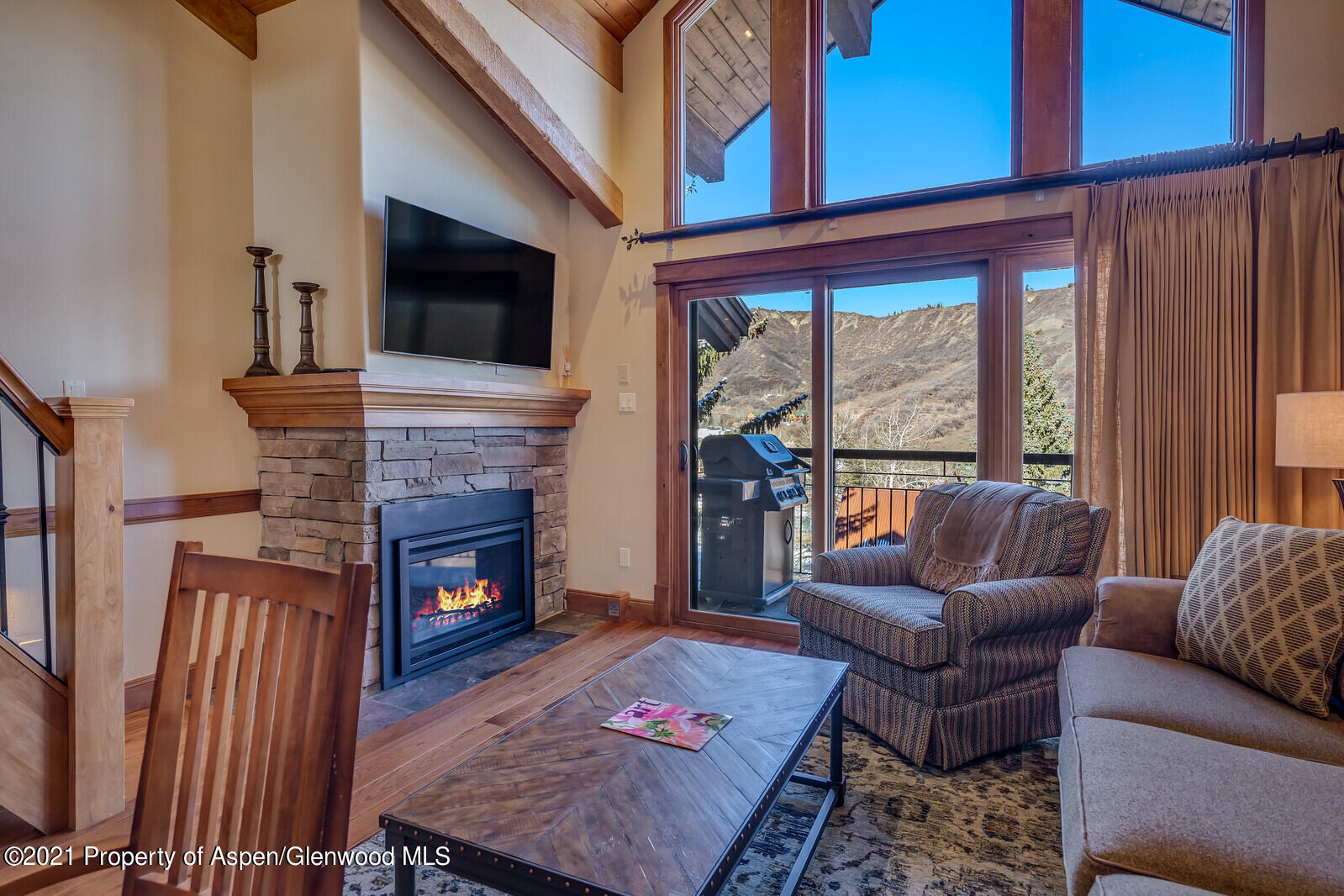 400 Wood Road, Unit 2302 Snowmass Village, CO 81615 - Photo 3 of 16 a living room with furniture a flat screen tv and a fireplace