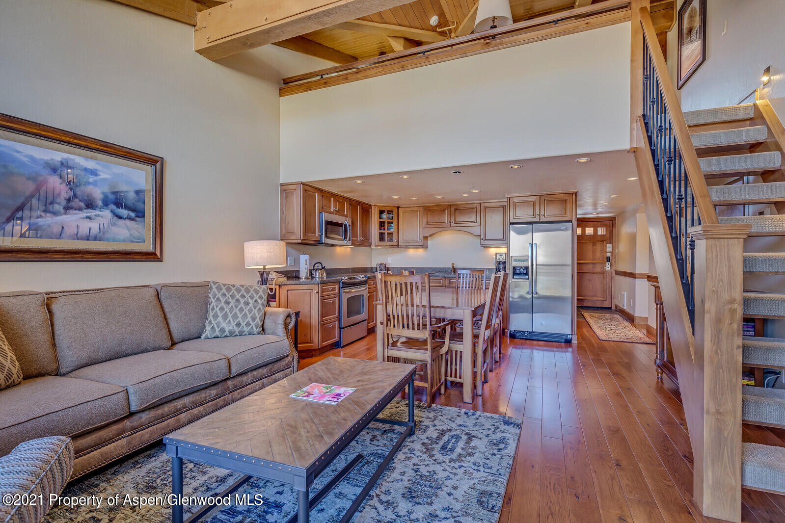 400 Wood Road, Unit 2302 Snowmass Village, CO 81615 - Photo 4 of 16 a living room with furniture and a wooden floor