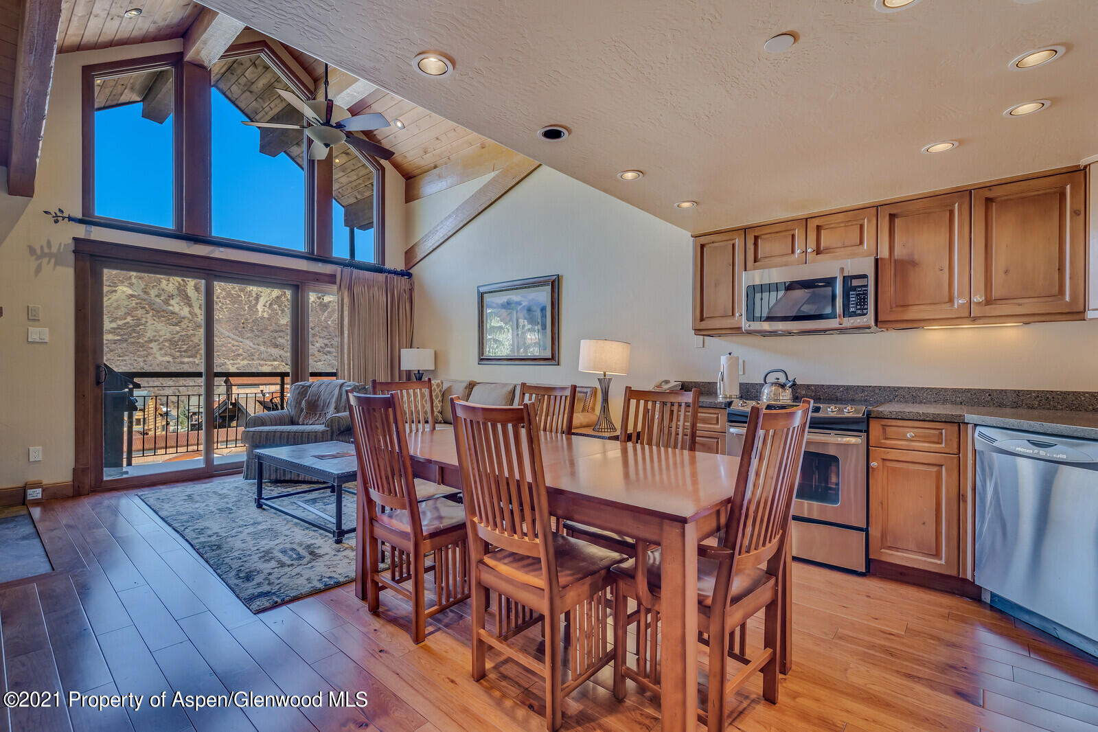 400 Wood Road, Unit 2302 Snowmass Village, CO 81615 - Photo 8 of 16 a view of a dining room with furniture window and wooden floor