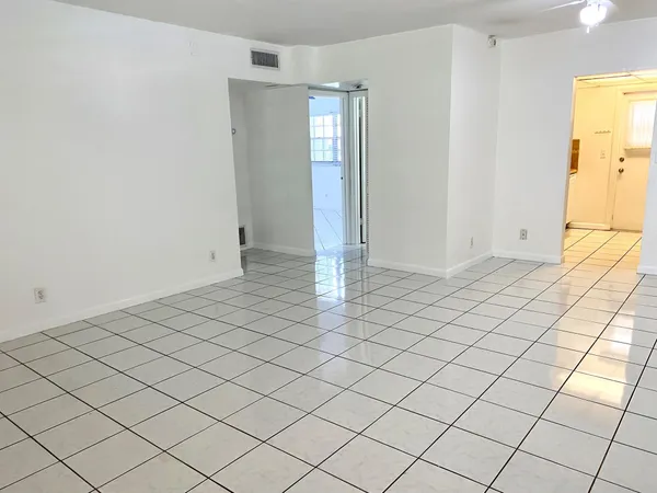 a view of an empty room and wooden floor
