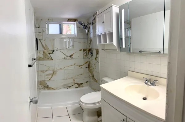 a bathroom with a sink toilet and shower