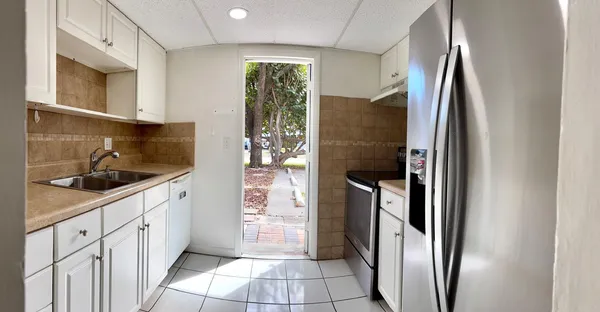 a kitchen with a refrigerator and cabinets